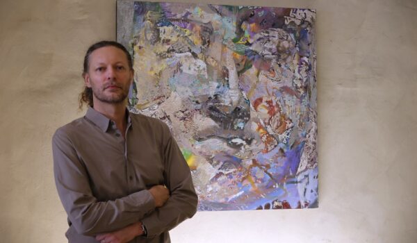 il pittore Ivan Mangov davanti a una sua tela