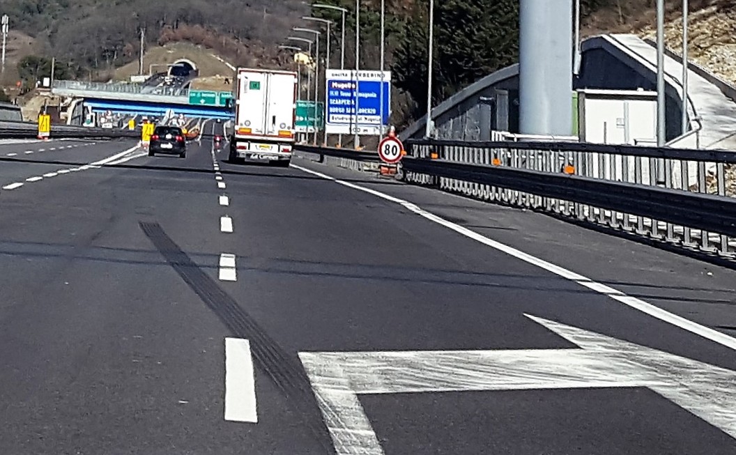 corsie autostradali, segnaletica, imbocco di tunnel sullo sfondo